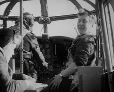 Women and a Pilot Sitting in the Cockpit of a Plane, 1942. Creator: British Pathe Ltd
