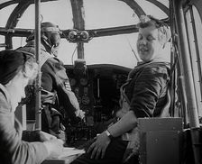 Women and a Pilot Sitting in the Cockpit of a Plane, 1942. Creator: British Pathe Ltd