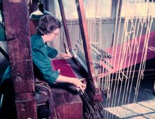 Women at a loom weaving cloth for state robes to be worn at the coronation of Elizabeth II, 1953. Creator: Arthur Charles Kirby Ware