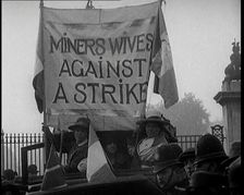 Women Gathering Around a Banner Reading Miners Wives Against a Strike 1920. Creator: British Pathe Ltd