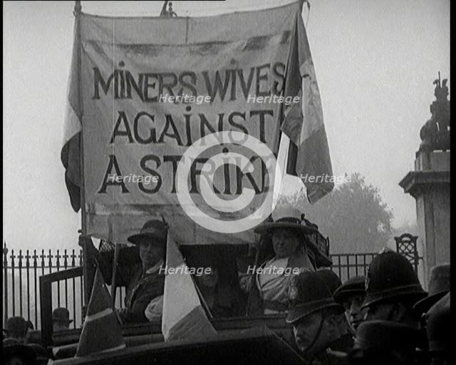 Women Gathering Around a Banner Reading 'Miners Wives Against a Strike', 1920. Creator: British Pathe Ltd.