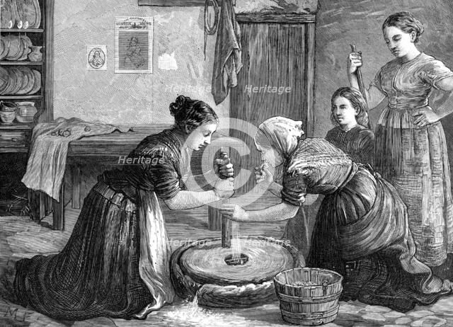 Women grinding corn in Ireland, 1874. Creator: Unknown.