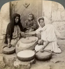 Women grinding at the mill, Palestine, 1900.Artist: Underwood & Underwood