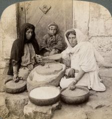 Women grinding at the mill, Palestine, 1900.Artist: Underwood & Underwood