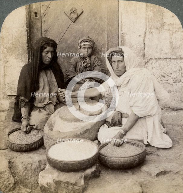 Women grinding at the mill, Palestine, 1900.Artist: Underwood & Underwood