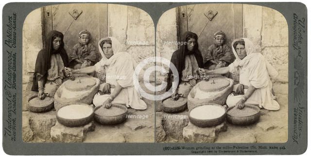 Women grinding at the mill, Palestine, 1900.Artist: Underwood & Underwood