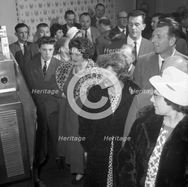 Women in fur coats at a food exhibition, Wilsic, near Doncaster, South Yorkshire, 1961.  Artist: Michael Walters