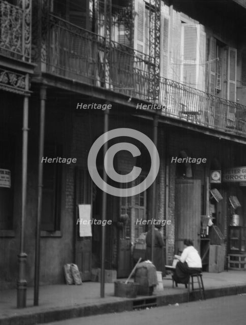 Women on a covered sidewalk, New Orleans, between 1920 and 1926. Creator: Arnold Genthe.