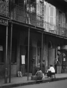Women on a covered sidewalk, New Orleans, between 1920 and 1926. Creator: Arnold Genthe