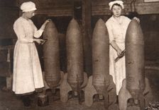 Women munitions workers putting a coat of paint on aerial bombs, World War I, c1914-c1918. Creator: S and G