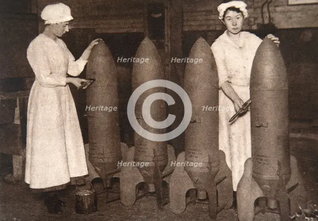 Women munitions workers putting a coat of paint on aerial bombs, World War I, c1914-c1918. Creator: S and G.