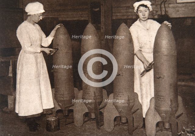 Women munitions workers putting a coat of paint on aerial bombs, World War I, c1914-c1918. Creator: S and G.