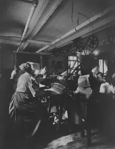 Women perforating sheets of stamps in the Stamp Division at the Bureau of Engraving..., c1895. Creator: Frances Benjamin Johnston