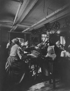 Women perforating sheets of stamps in the Stamp Division at the Bureau of Engraving..., c1895. Creator: Frances Benjamin Johnston