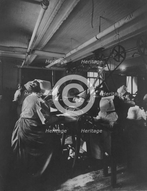 Women perforating sheets of stamps in the Stamp Division at the Bureau of Engraving..., c1895. Creator: Frances Benjamin Johnston.
