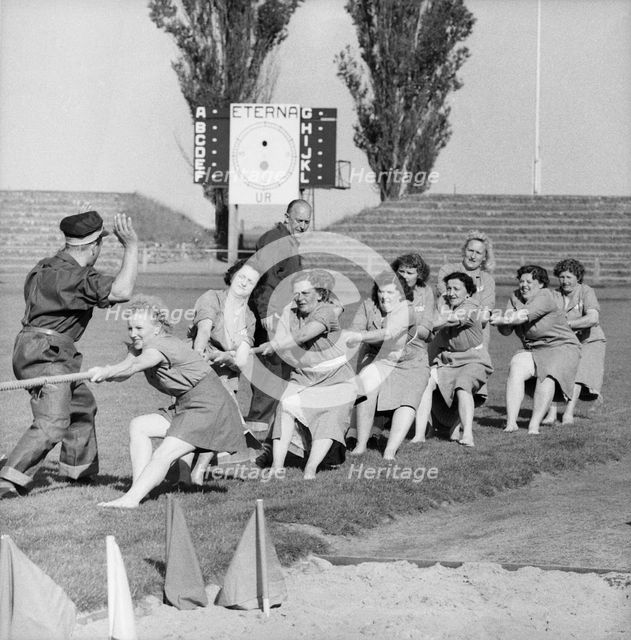 Women's tug of war team in action, Landskrona Stadium, Sweden, 1957. Creator: Unknown.