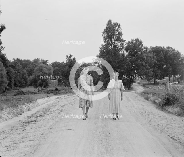 Women walking down the road to see a sick neighbor, Person County, North Carolina, 1939. Creator: Dorothea Lange.