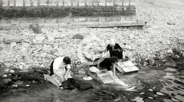 Women washing clothes on the shore of Lago Maggiore, Isola Bella, Italy, c1955.  Creator: Arthur Charles Kirby Ware.