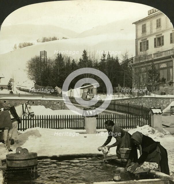 Women washing clothes at the public fountain in midwinter, Zuoz, Switzerland. Artist: HC White