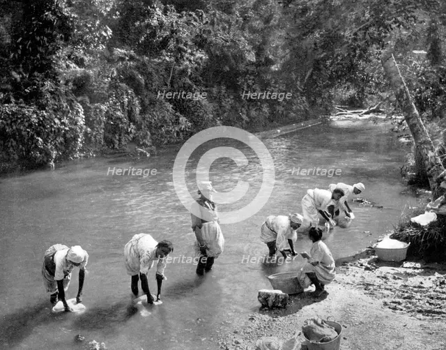 Women washing clothes in the river, Port Antonio, Jamaica, c1905. Artist: Adolphe Duperly & Son