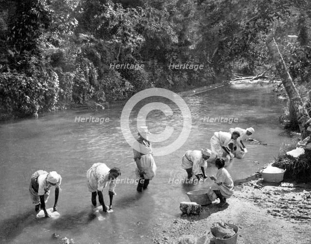 Women washing clothes in the river, Port Antonio, Jamaica, c1905. Artist: Adolphe Duperly & Son