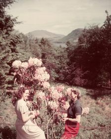 Women with rhododendrons, Derwentwater, Lake District, c1955. Creator: Arthur Charles Kirby Ware