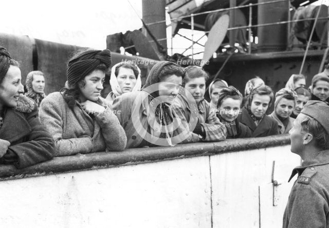Women talking to a soldier, Trelleborg harbour, Sweden, May 1945. Creator: Unknown.