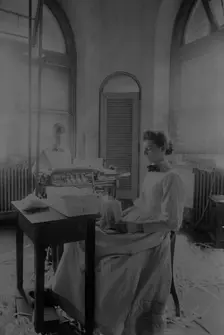 Women trimming and stacking currency sheets at the Bureau of Engraving & Printing, c1890. Creator: Frances Benjamin Johnston
