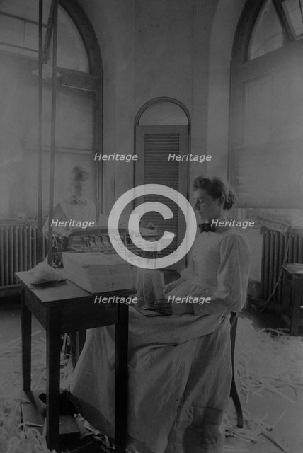 Women trimming and stacking currency sheets at the Bureau of Engraving & Printing, c1890. Creator: Frances Benjamin Johnston.