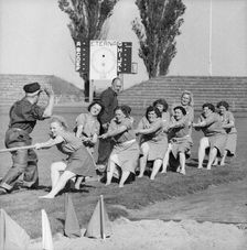 Women's tug of war team in action, Landskrona Stadium, Sweden, 1957