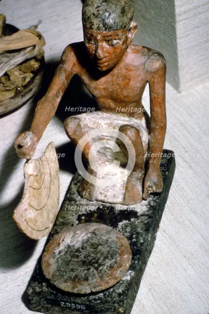 Wooden Model of Man fanning Fire, Egyptian  Tomb Finding, c1900 BC.  Artist: Unknown.