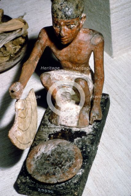 Wooden Model of Man fanning Fire, Egyptian  Tomb Finding, c1900 BC.  Artist: Unknown.