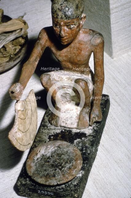 Wooden Model of Man fanning Fire, Egyptian  Tomb Finding, c1900 BC.  Artist: Unknown.