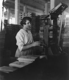 Wooden Box Industry: young woman working at machine, c1910. Creator: Frances Benjamin Johnston