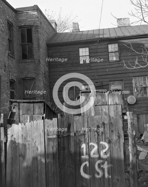 Wooden privies in the Negro area, Washington (southwest section), D.C., 1942. Creator: Gordon Parks.