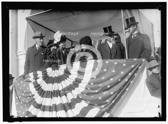 Woodrow Wilson and wife Ellen with unidentified on viewing stand, between 1910 and 1914. Creator: Harris & Ewing.