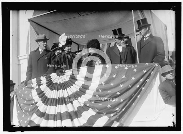 Woodrow Wilson and wife Ellen with unidentified on viewing stand, between 1910 and 1914. Creator: Harris & Ewing.