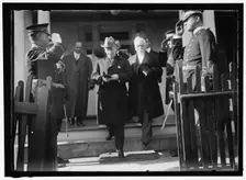 Woodrow Wilson descending steps with unidentified persons, between 1910 and 1917. Creator: Harris & Ewing