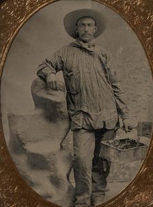 Workman Holding Brush and Rectangular Tray, Arm Resting on Fake Rock, 1860s-80s. Creator: Unknown