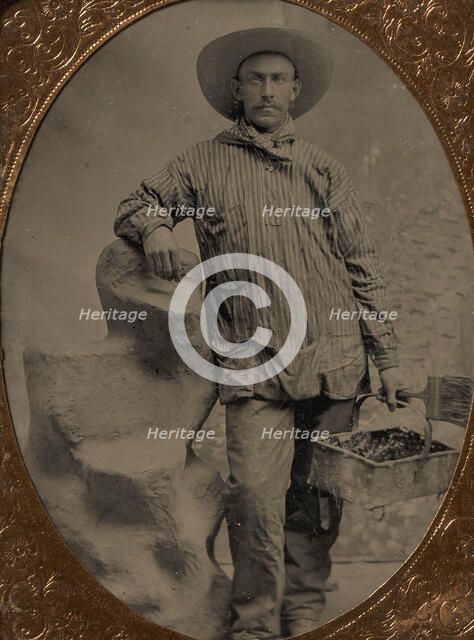 Workman Holding Brush and Rectangular Tray, Arm Resting on Fake Rock, 1860s-80s. Creator: Unknown.