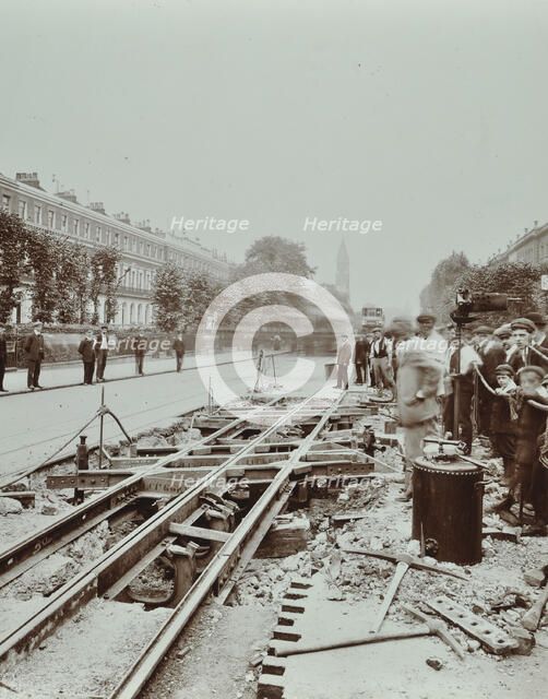 Workmen extending tramlines, Brixton Road, London, 1907. Artist: Unknown.