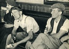 Workmen in an English inn listening to Mr. Churchill 1942. Creator: Unknown