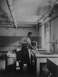 Worker prepares gum for postage stamps in the Stamp Division at the Bureau of Engraving..., c1895. Creator: Frances Benjamin Johnston