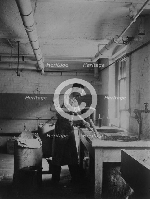 Worker prepares gum for postage stamps in the Stamp Division at the Bureau of Engraving..., c1895. Creator: Frances Benjamin Johnston.