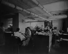 Workers taking mucilaged sheets of postage stamps from the drying box in the gumming..., c1895. Creator: Frances Benjamin Johnston