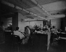 Workers taking mucilaged sheets of postage stamps from the drying box in the gumming..., c1895. Creator: Frances Benjamin Johnston