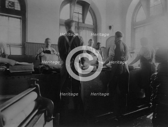 Workers wetting sheets prior to printing paper money at the Bureau of Engraving & Printing, c1895. Creator: Frances Benjamin Johnston.