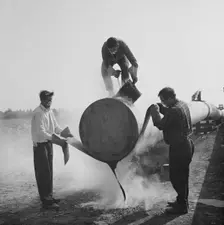 Workers wrapping and sealing the end of a steel pipe on the Fens gas pipeline, Norfolk, 24/07/1967. Creator: John Laing plc