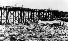 Workers below Victoria Bridge, cleaning up debris after the flood, Brisbane, 1893. Creator: Unknown