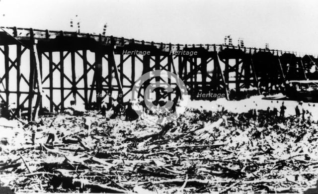 Workers below Victoria Bridge, cleaning up debris after the flood, Brisbane, 1893. Creator: Unknown.